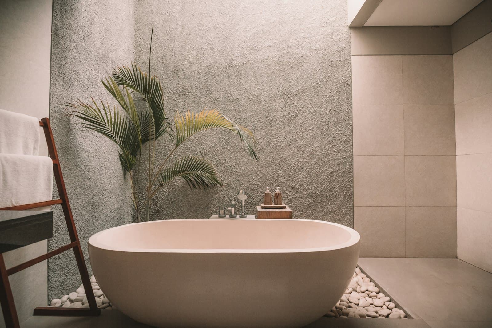 Freestanding soaking tub beside a sunlit window
